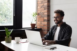 Life insurance agent reading article on computer about Maximizing Life Insurance Sales in the Digital Age