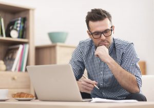 Life Insurance Agent Looking at Laptop Reading Finding Organic Annuity Leads: A Guide for Life Insurance Agents