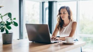 Woman on Laptop Reading the Article Where Can Life Insurance Agents Find the Best Aged Leads