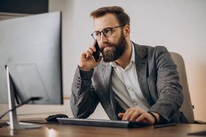Life Insurance agent looking at computer reading about Where to Find Quality, Affordable Leads for Life Insurance Agents