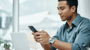 Life Insurance Agent Looking at Cell Phone