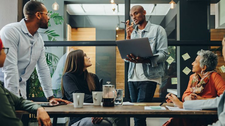 Group of Life Insurance Agents Discussing AI in Office